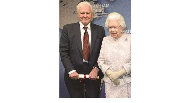 Queen Elizabeth stands beside broadcaster and conservationist David Attenborough after presenting him with the 2019 Chatham House Prize, at Chatham House in central London.