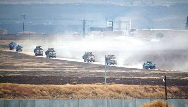 Turkish and Russian military vehicles return following a joint patrol in northeast Syria, as they are pictured near the Turkish border town of Kiziltepe in Mardin province, yesterday.