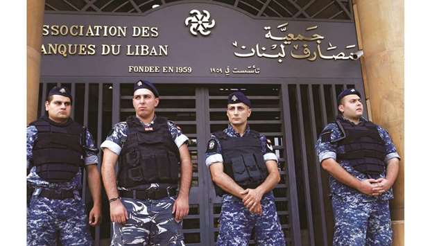 Lebanese police stand outside the entrance to the Association of Banks in downtown Beirut on Friday. Lebanese banks have curtailed the transfer of dollar deposits abroad until political turbulence that has engulfed the country and raised fears of a collapse in its currency peg subsides.