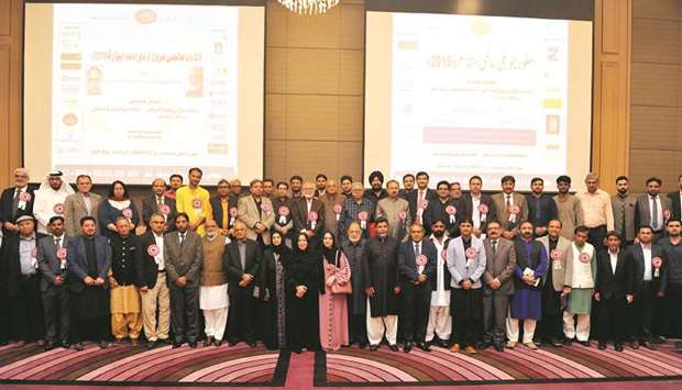 GROUP: Poets, guests, organisers, and community members seen in a group photo during the 25th annual mushaira of the Majlis-e-Frogh-e-Urdu Adab (MFUA).