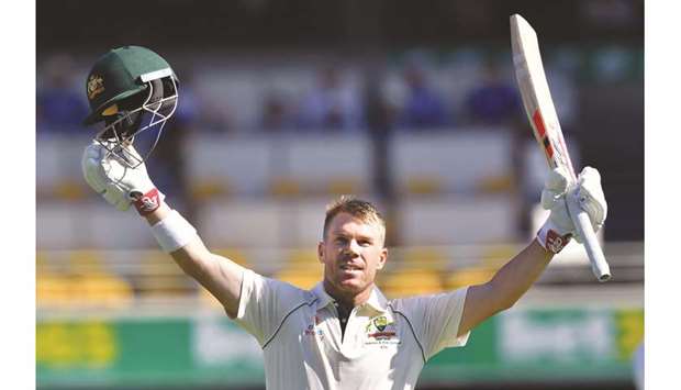 Australiau2019s batsman David Warner celebrates reaching his century on day two of the first Test against Pakistan at the Gabba in Brisbane yesterday. (AFP)