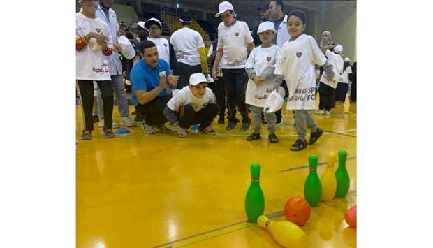 Children take part in the 13th Entertainment Day for people with special needs at the Qatar Sport Club yesterday.
