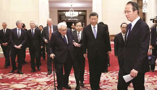Chinau2019s President Xi Jinping (centre R) and former US secretary of state Henry Kissinger (centre L) walk to a meeting with delegates from the 2019 New Economy Forum at the Great Hall of the People in Beijing yesterday. u201cAs we always said we donu2019t want to start the trade war but we are not afraid,u201d Xi said at the meeting.