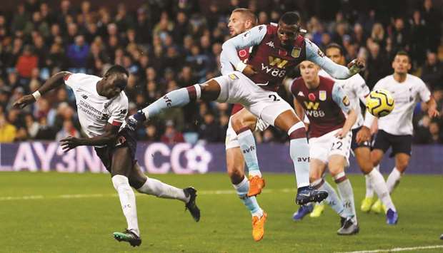 Liverpoolu2019s Sadio Mane (left) scores their second goal during the English Premier League match against Aston Villa in Birmingham, United Kingdom, yesterday. (Reuters)