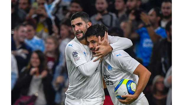 Marseilleu2019s Morgan Sanson (right) celebrates with teammate Alvaro Gonzalez after scoring a goal during the Ligue 1 match against Olympique de Marseille in Marseille, France, yesterday. (AFP)