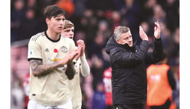 Manchester United manager Ole Gunnar Solskjaer (right) applauds the fans after the match against Bournemouth in Bournemouth, United Kingdom, yesterday. (Reuters)