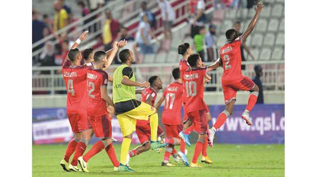 Al Duhail players celebrate their win over Al Sadd in the QNB Stars League Saturday. At bottom, Edmilson reacts after scoring for Duhail.