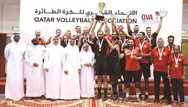 Super Cup winners Al Rayyan pose with the trophy in the presence of volleyball officials at the Qatar Volleyball Association hall yesterday.