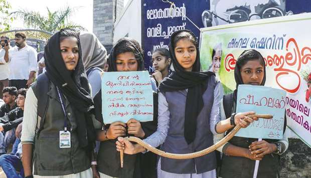Students hold placards and a toy snake during a protest yesterday over the death of a girl after she was bitten by a snake inside her classroom at Sulthan Bathery in Wayanadu2019s district in Kerala.