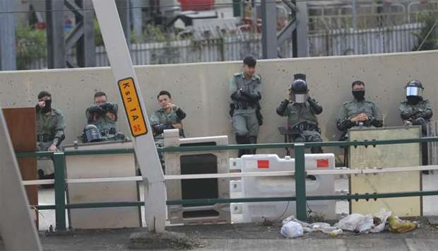 Police guard the perimeter of Hong Kong Polytechnic University (PolyU) in Hong Kong