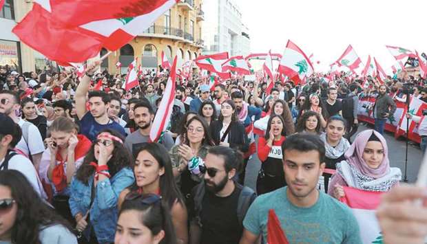 Lebanese demonstrators take part in a civilian Independence Day parade in Beirutu2019s Martyr Square yesterday, more than a month into protests demanding an overhaul of the entire political system.