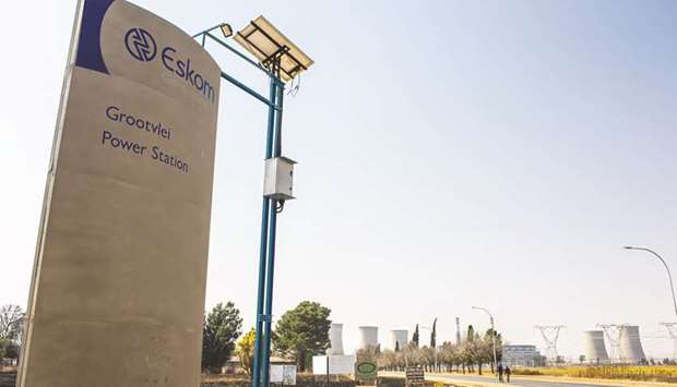 A sign stands outside the entrance road to the Eskom Holdingsu2019 Grootvlei coal-fired power station in Mpumalanga (file). South Africau2019s finances are deteriorating due to billions of dollars in bailouts for unprofitable power producer Eskom.