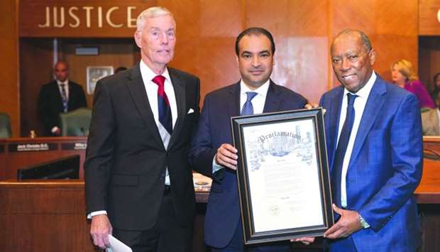 Qataru2019s consul general in Houston Rashid al-Dehaimi (middle) and other officials show off the proclamation