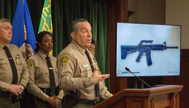 Los Angeles County Sheriff, Alex Villanueva, speaks beside an image of a seized semi-automatic weapon as he briefs the media after the arrest of a 13-year-old boy who allegedly threatened to carry out a shooting at Animo Mae Jemison Charter Middle School, in Los Angeles, California