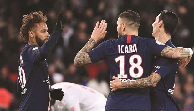 Paris Saint-Germainu2019s Argentine forward Mauro Icardi (centre) is congratulated by Brazilian forward Neymar (left) and Argentine midfielder Angel Di Maria after scoring a goal against Lille in Paris on Friday. (AFP)