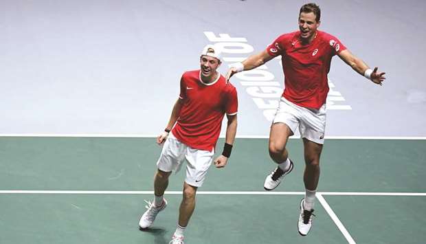 Canadau2019s Denis Shapovalov (left) and Vasek Pospisil celebrate after winning the semi-final doubles tennis match against Russia at the Davis Cup Finals 2019 in Madrid, Spain, yesterday. (AFP)