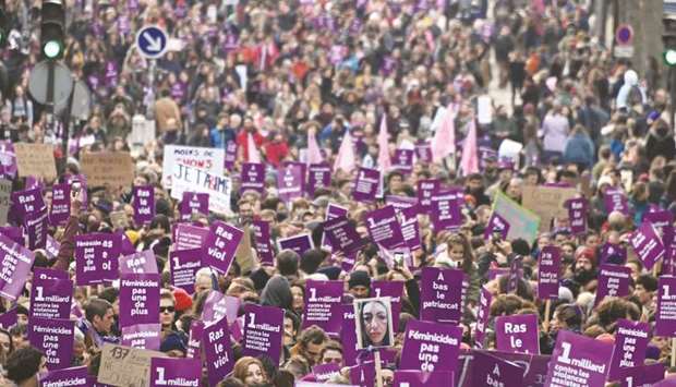 People take part in a protest in Paris to condemn violence against women.