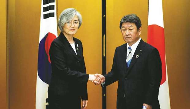Japanese Foreign Minister Toshimitsu Motegi, right, shakes hands with South Koreau2019s Foreign Minister Kang Kyung-wha before a bilateral meeting at the G20 Foreign Ministersu2019 meeting in Nagoya yesterday.