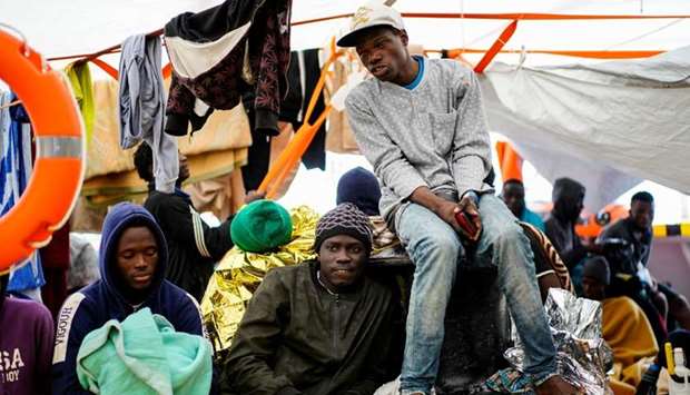 Migrants rest on board a NGO Proactiva Open Arms rescue boat in the central Mediterranean Sea