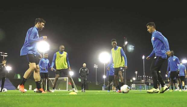 Qatar players take part in a training session yesterday. (Right) Qatar head coach Felix Sanchez. PICTURES: Fadi al-Assaad