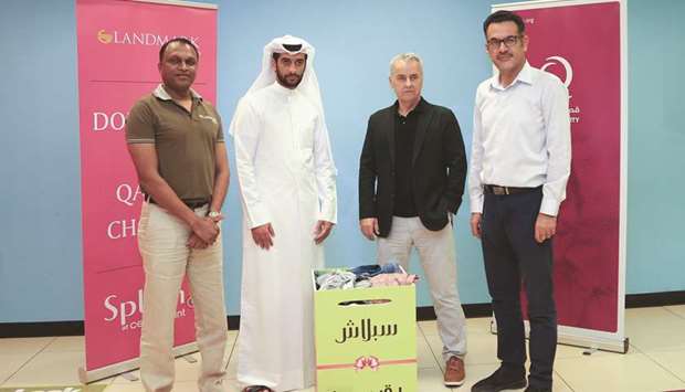 Qatar Charity and Landmark Group officials.