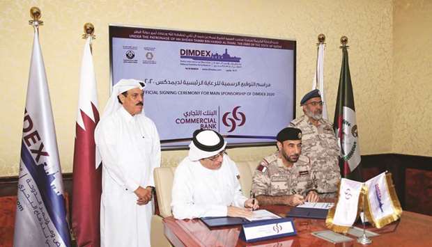 HE the Chief of Staff of Qatar Armed Forces Lieutenant General (Pilot) Ghanem bin Shaheen al-Ghanem, and Commercial Bank board member Abdulrahman bin Hamad al-Attiyah look on as Commercial Banku2019s senior official Khalifa al-Rayes and Dimdex chairman Staff Brigadier (Sea) Abdulbaqi Saleh al-Ansari sign the agreement.