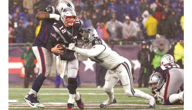 New England Patriots quarterback Tom Brady (centre) tries to evade a tackle by Dallas Cowboys defensive end Kerry Hyder during the first half at Gillette Stadium. PICTURE: USA TODAY Sports