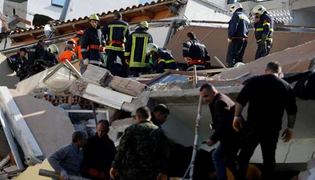 Emergency personnel work at the site of a collapsed building in Durres, after an earthquake shook Albania