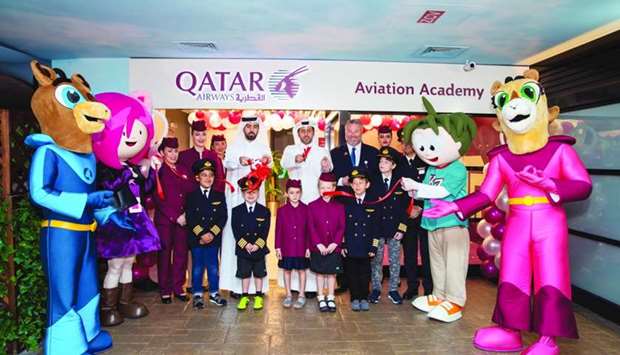 Officials at the opening of the Aviation Academy with children. Supplied picture