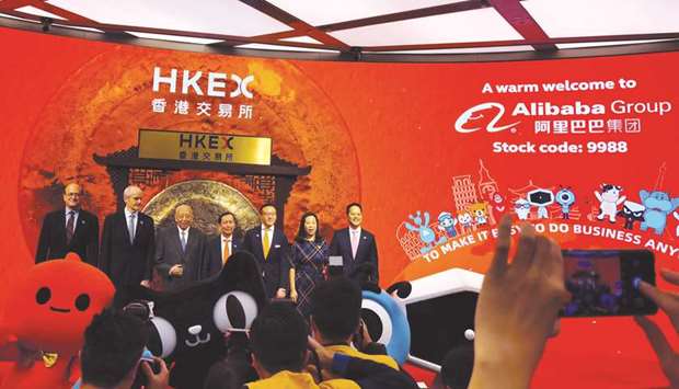 Alibabau2019s chairman and chief executive officer Daniel Zhang, vice chairman Joseph Tsai and former Hong Kong chief executive Tung Chee-hwa attend the listing ceremony at the Hong Kong Stock Exchange yesterday.