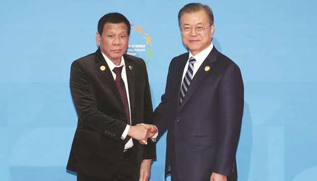South Korean President Moon Jae-in shakes hands with President Rodrigo Duterte  during the Asean-Republic of Korea Commemorative Summit in Busan, yesterday.