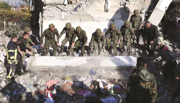 Emergency workers clear debris at a damaged building in Thumane, 34km northwest of Tirana.