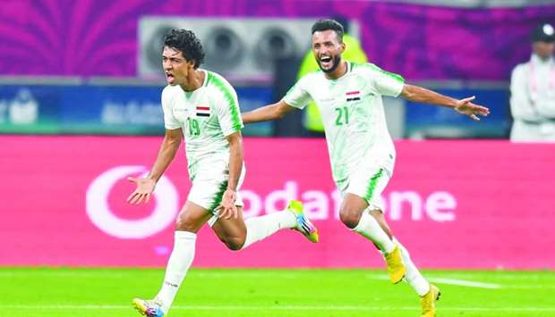 Iraqu2019s Mohamed Qasem (left) celebrates after scoring a goal against Qatar during the Arabian Gulf Cup match at Khalifa International Stadium in Doha Tuesday. PICTURES: Noushad Thekkayil, Ram Chand
