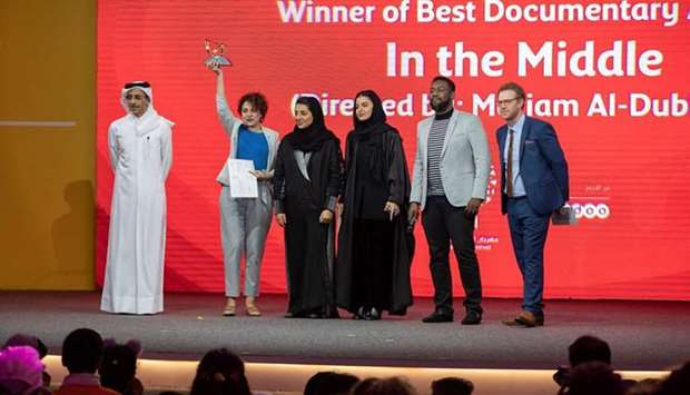 Mariam al-Dhubhani, director of In the Middle, receives her award for Best Documentary at Ajyalu2019s closing ceremony.