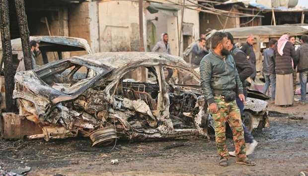 A picture taken yesterday shows destroyed vehicles following a car bomb attack at a local market in Tal Halaf village along the border with Turkey, yesterday.