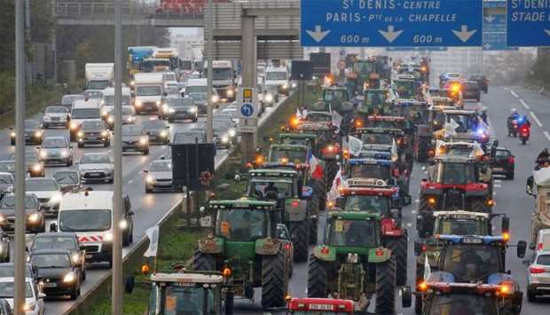 French farmers drive their tractors on the A1 Lille-Paris motorway near Le Bourget on their way to Paris, protesting against low farm incomes and growing criticism of agricultural practices, France