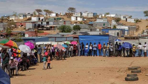 Namibians wait in line to access a polling station during the Namibian Presidential and parliamentary elections in Windhoek, Namibia.