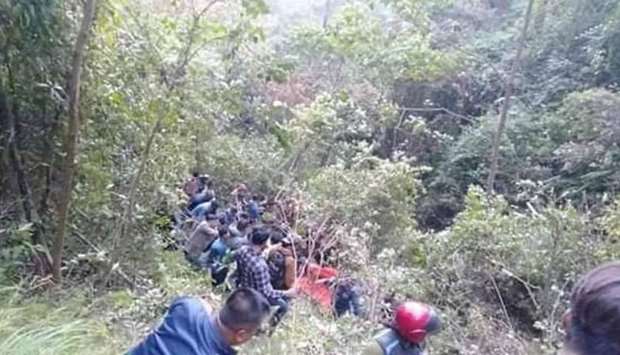 Rescuers go down the gorge to the crashed bus