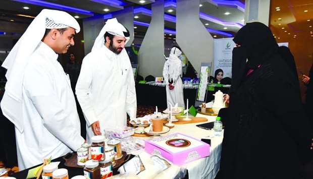 Al Meera IT director Mohamed al-Bader (left) viewing the products on display during the event held at Katara. PICTURE: Noushad Thekkayil