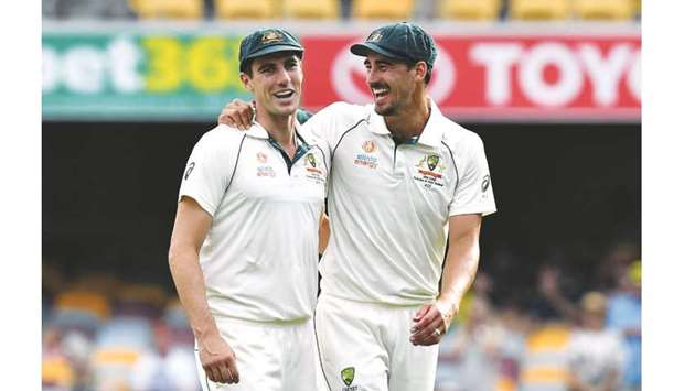 Australiau2019s paceman Mitchell Starc (right) and Pat Cummins celebrate their victory in the first Test against Pakistan at the Gabba in Brisbane on November 24, 2019. (AFP)
