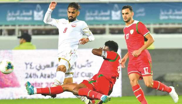 Action from the Gulf Cup match between Oman (in red) and Bahrain (in white) at Abdullah Bin Khalifa Stadium yesterday.