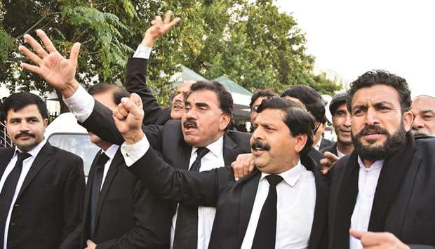 Lawyers supporting army chief Bajwa chant slogans in reaction to the Supreme Court ruling.