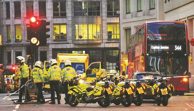 Police and emergency vehicles gather at Leadenhall near London Bridge in central London yesterday.