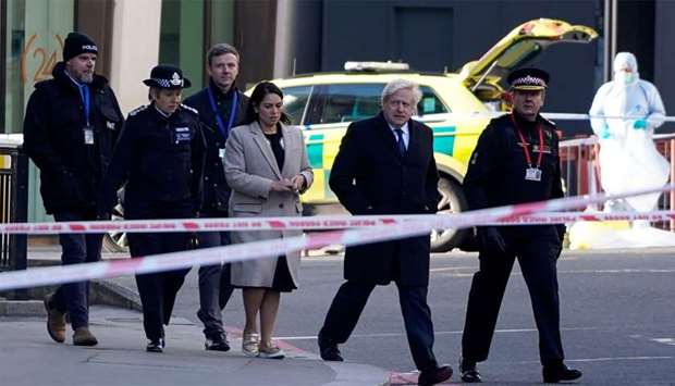 Britain's Prime Minister Boris Johnson, (2R), Britain's Home Secretary Priti Patel, (3L), Metropolitan Police Commissioner Cressida Dick (2L) and Commissioner of the City of London Police, Ian Dyson (R) arrive at the scene of a stabbing on London Bridge in the City of London