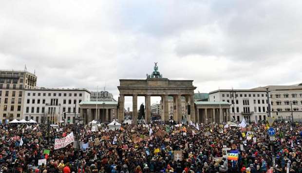 A general view shows demonstrators as they gather with placards in front of Brandenburg Gate during a protest called by the Fridays for Future movement for climate protection in Berlin