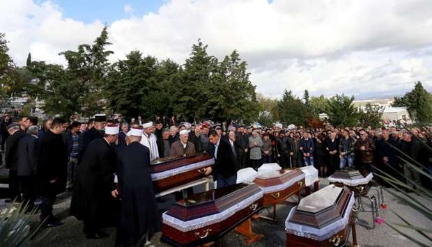 Relatives and family attend the funeral of eight Lala family members who died during the earthquake in Durres