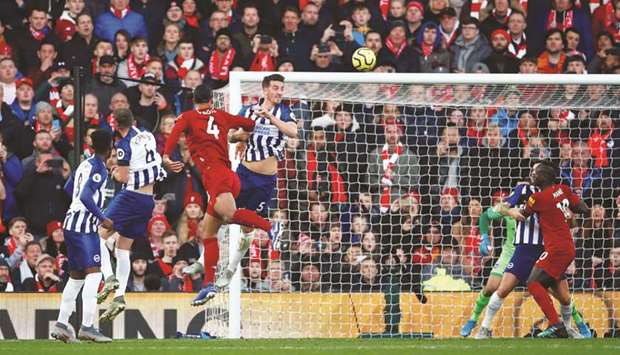 Liverpoolu2019s Virgil van Dijk scores their second goal against Brighton during their EPL match yesterday. (Reuters)