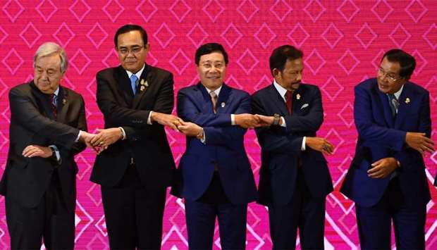 (From L to R) UN Secretary-General Antonio Guterres, Thailand's Prime Minister Prayut Chan-O-Cha, Vietnam's Foreign Minister Pham Binh Minh, Brunei's Sultan Hassanal Bolkiah and Cambodia's Prime Minister Hun Sen prepare to pose for a group photo during the 10th ASEAN-UN Summit in Bangkok