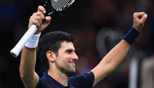 Serbia's Novak Djokovic celebrates winning against Canada's Denis Shapovalov during their men's singles final tennis match at the ATP World Tour