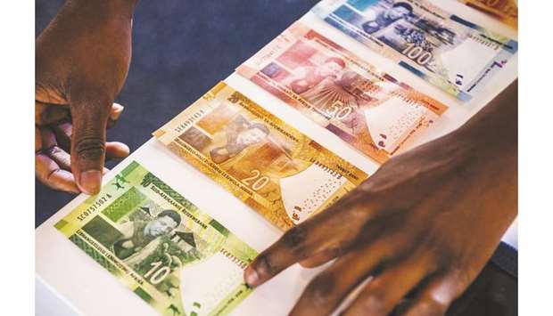 Commemorative South African rand banknotes sit on display in Pretoria, South Africa (file). The rand has tumbled nearly 4% over the past six months, the fourth-most in the developing world.